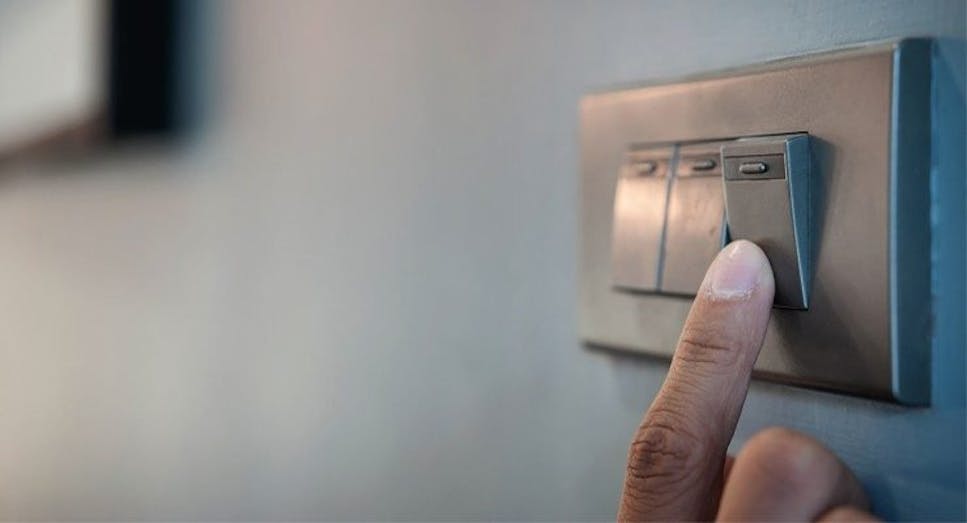 Hand on light switch