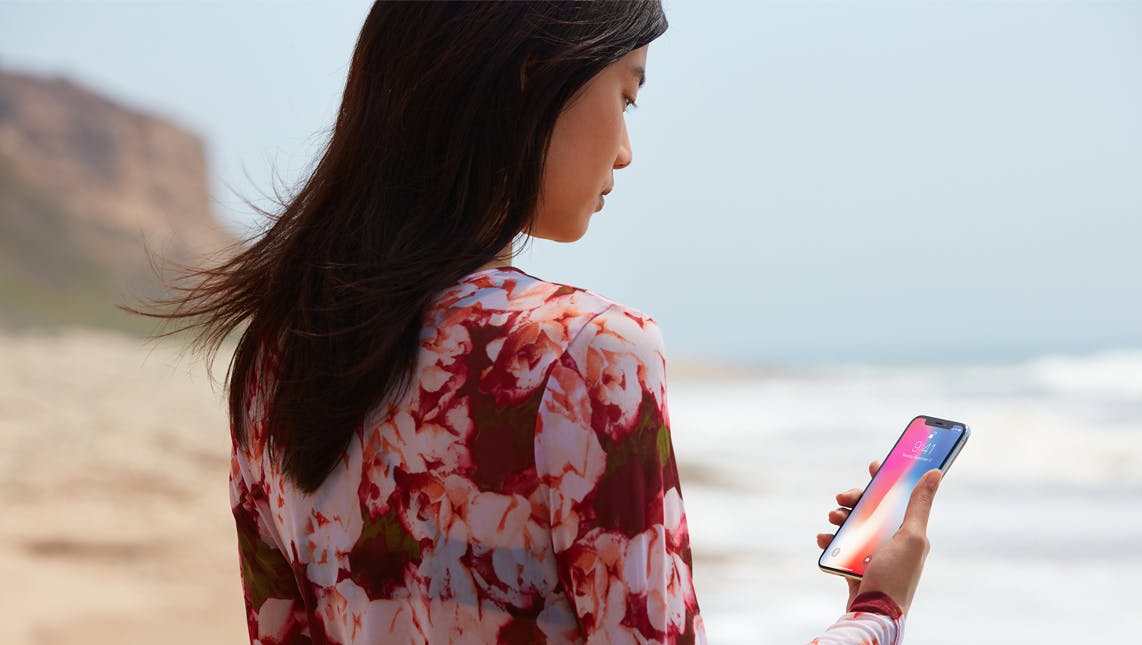 Woman with phone on beach