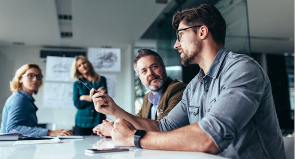 Four professionals in an office having a meeting