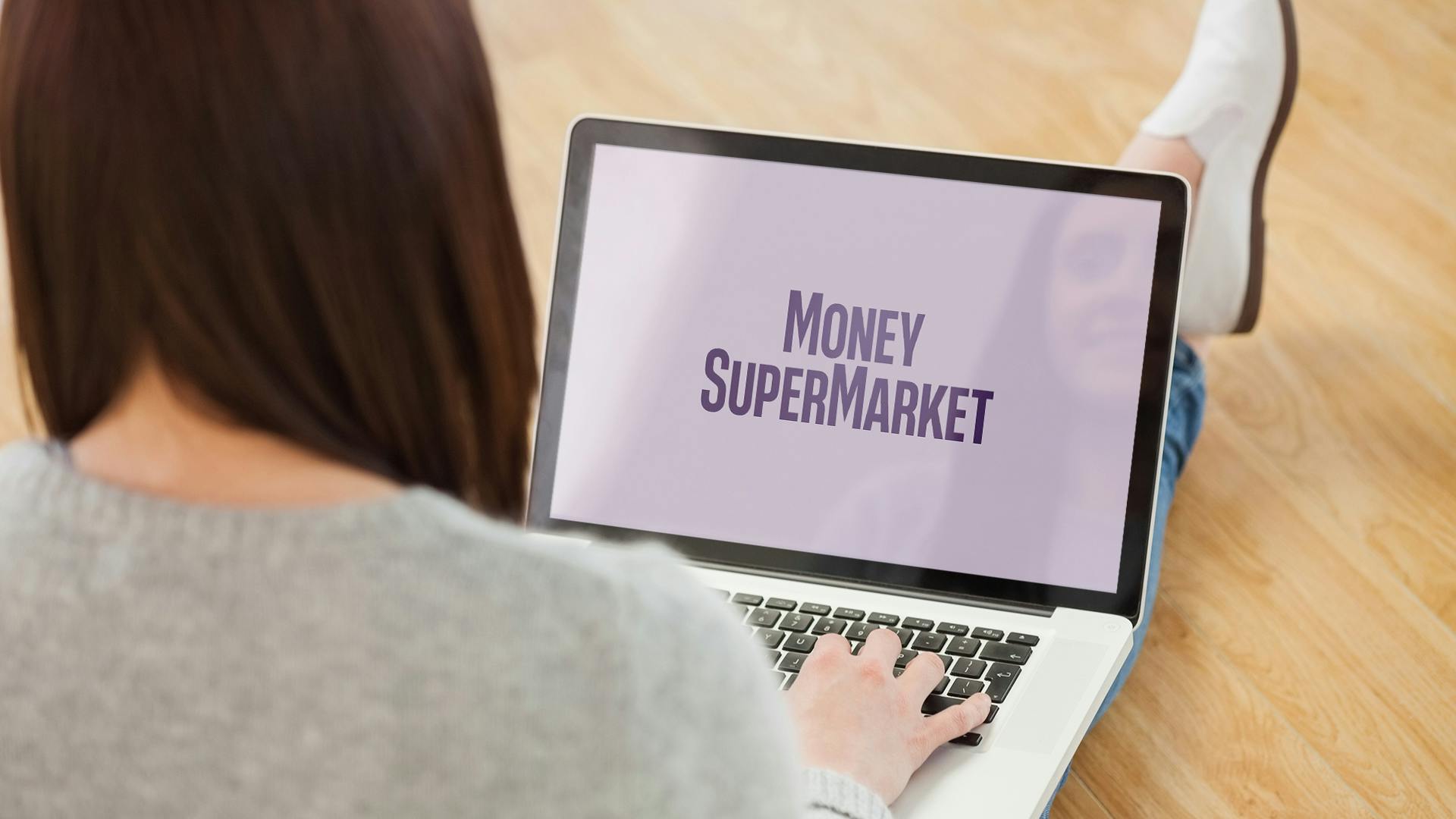Woman on laptop with MoneySuperMarket logo displayed