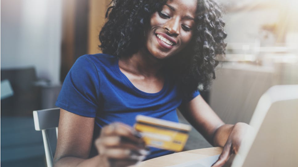 hero-homepage-woman-credit-card-debit-card-spending-online-shopping.png