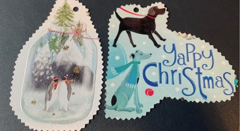 Two Christmas gift tags made from recycled Christmas cards, cut with pinking shears