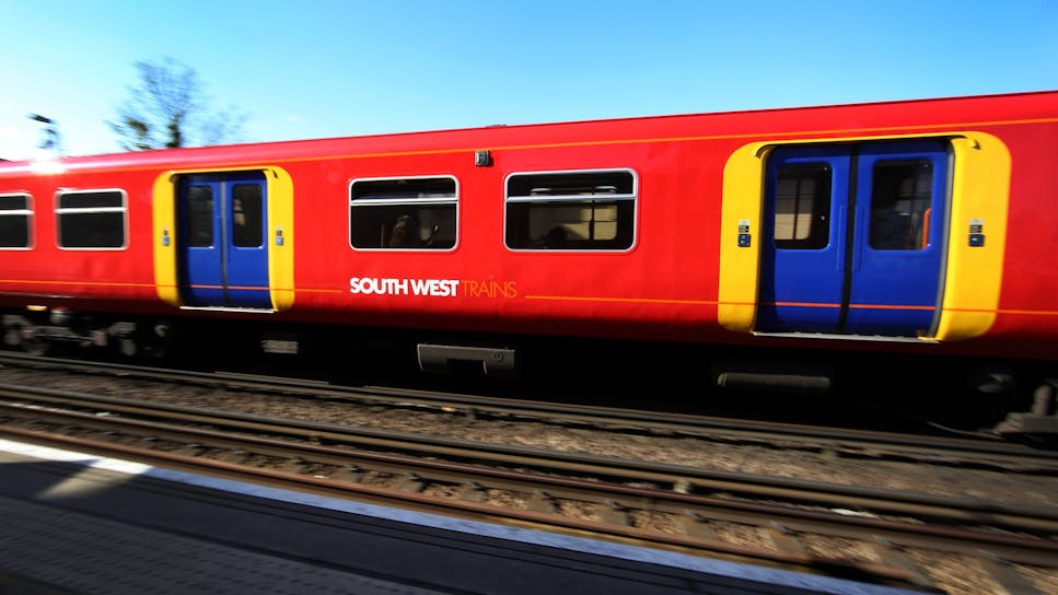 Brightly coloured South West train at station