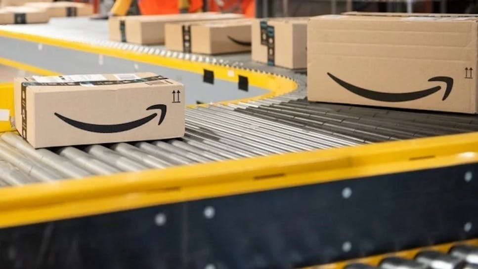 Amazon boxes on a conveyor belt in a factory style setting