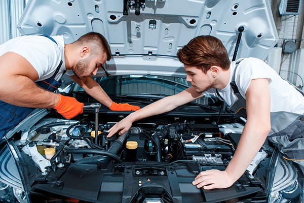 Mechanics working on car