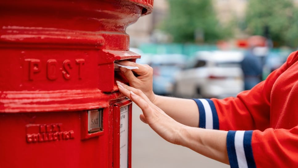 A letter being posted into a postbox, labelled 'post'.