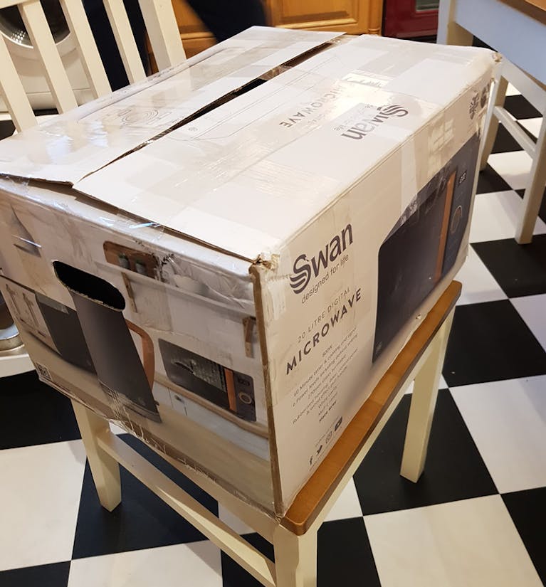 Swan microwave in a slightly damaged box
