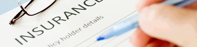 Close-up of an insurance claim form, with the words "policy holder details" visible.
