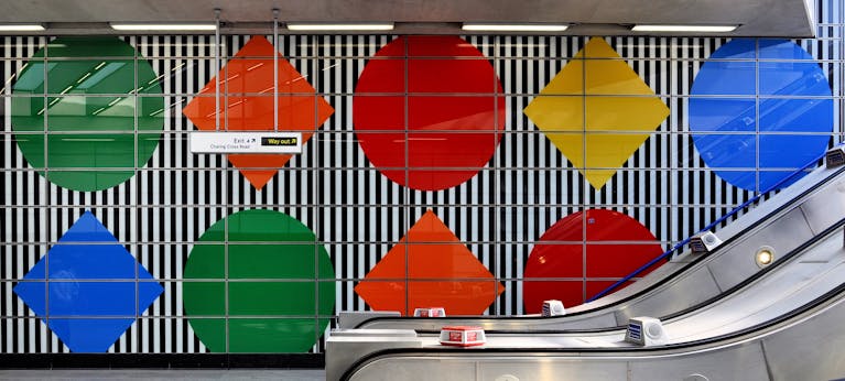 Artwork of big diamonds and circles in bright, solid colours at Tottenham Court Road station