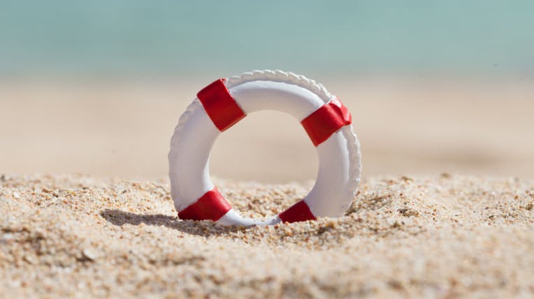 hero-homepage-tip-travel-insurance-holiday-book-beach-rescue.png