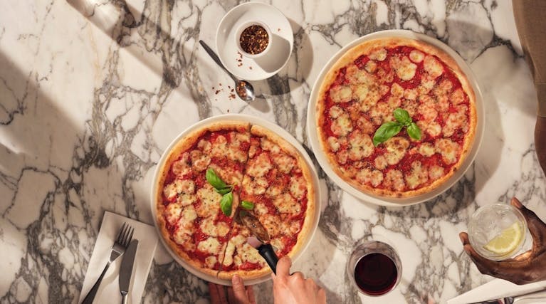 two pizzas on a table