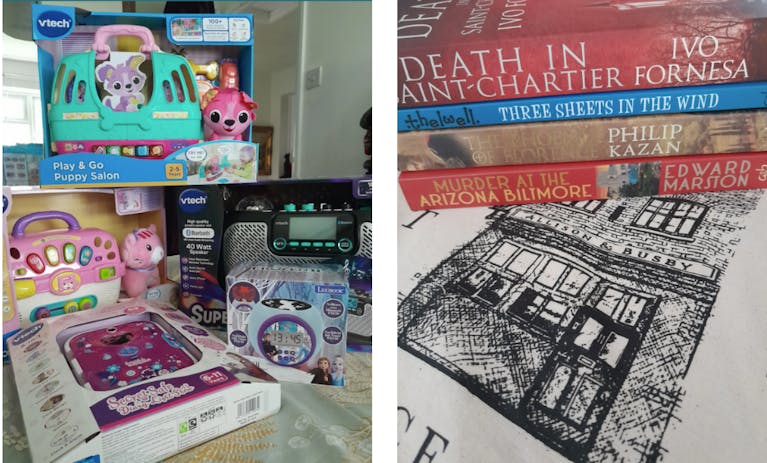 A stack of kids' toys, a stack of books and a tote bag