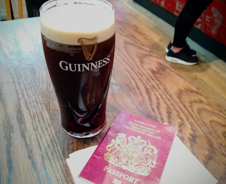 Pint of Guinness and UK passport.