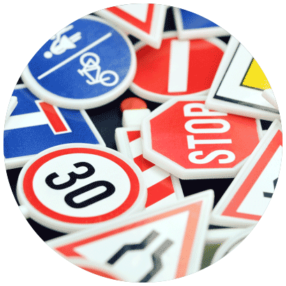 Close-up of a variety of road signs, including "30" and "stop".
