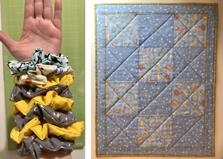An upright arm displaying multiple hair scrunchies, and a homemade quilt