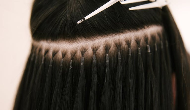 Long, dark brown hair shown from behind, with extensions fixed in place