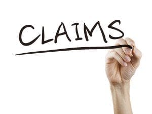 Hand writing 'CLAIMS' with a marker pen.